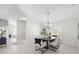 Bright and airy dining room with modern chandelier and neutral decor at 1527 Buoy Ln, Osprey, FL 34229