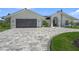 Charming single-story home boasting a paved driveway, attached garage, and well-maintained landscaping at 1527 Buoy Ln, Osprey, FL 34229