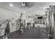 Fully equipped gym with machines, free weights, mirrors, ceiling fans, and access to outdoors at 1527 Buoy Ln, Osprey, FL 34229