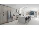 Modern kitchen with stainless steel appliances, a spacious island, and stylish light fixtures at 1527 Buoy Ln, Osprey, FL 34229