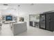 Open concept kitchen with an island, a wine fridge and views into the living area at 1527 Buoy Ln, Osprey, FL 34229
