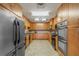 Well-lit kitchen features wood cabinetry, stainless steel appliances, tile backsplash, and tiled floors at 1527 Buoy Ln, Osprey, FL 34229