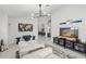 Bright living room with modern seating, large windows, and decor at 1527 Buoy Ln, Osprey, FL 34229