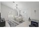 Bright living room featuring modern lighting, large windows, and tile floors at 1527 Buoy Ln, Osprey, FL 34229
