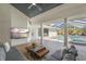 Inviting outdoor patio with stylish seating, a modern coffee table, and a view of the sparkling pool and hot tub at 1527 Buoy Ln, Osprey, FL 34229