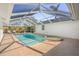 Spacious screened-in pool featuring a hot tub, plenty of room for outdoor seating, and a fully screened enclosure at 1527 Buoy Ln, Osprey, FL 34229
