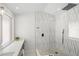 Walk-in shower featuring a glass enclosure, modern fixtures, and patterned geometric tiling at 1527 Buoy Ln, Osprey, FL 34229