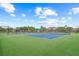 Well-maintained tennis court featuring a green playing surface and complete with a shaded viewing area at 1527 Buoy Ln, Osprey, FL 34229