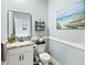 Bathroom with a framed mirror, storage shelving, and modern fixtures at 17547 Cantarina Cv, Bradenton, FL 34211