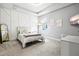 Comfortable bedroom featuring custom decorative wall paneling and neutral tones at 17547 Cantarina Cv, Bradenton, FL 34211