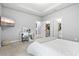 Bedroom boasting a vanity and entries to the walk-in closet and bathroom at 17547 Cantarina Cv, Bradenton, FL 34211