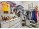 Organized walk-in closet featuring shelving, drawers, and hanging storage at 17547 Cantarina Cv, Bradenton, FL 34211