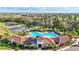 Aerial view of the community pool and clubhouse featuring a beautiful design and ample seating at 17547 Cantarina Cv, Bradenton, FL 34211