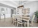 Well-appointed dining area with modern lighting, stylish furnishings, and a welcoming atmosphere for gatherings at 17547 Cantarina Cv, Bradenton, FL 34211