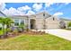 Charming single-story home with a well-manicured lawn, stone accents, and a three-car garage at 17547 Cantarina Cv, Bradenton, FL 34211