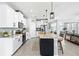 Modern kitchen featuring white cabinetry, stainless steel appliances, a spacious island, and an open layout at 17547 Cantarina Cv, Bradenton, FL 34211