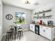 Bright kitchen boasts a cozy breakfast nook and custom coffee bar with ample storage and sleek countertops at 17547 Cantarina Cv, Bradenton, FL 34211