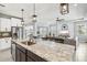 Beautiful kitchen showcasing a large island, granite countertops, pendant lighting, and an open-concept design at 17547 Cantarina Cv, Bradenton, FL 34211