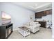 Cozy living room area with a small kitchenette featuring dark cabinetry at 17547 Cantarina Cv, Bradenton, FL 34211