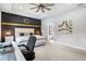 Stylish main bedroom features a decorative accent wall, a fan, and a trey ceiling at 17547 Cantarina Cv, Bradenton, FL 34211
