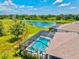 Aerial view of a screened-in pool with a lake view, offering a private and serene backyard experience at 17547 Cantarina Cv, Bradenton, FL 34211
