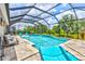 This inviting screened pool has lounge chairs and a spa, creating a luxurious outdoor experience with stunning views at 17547 Cantarina Cv, Bradenton, FL 34211