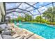 The spacious screened-in pool area features a spa, water feature, and plenty of room for lounging and recreation at 17547 Cantarina Cv, Bradenton, FL 34211