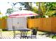 Backyard patio area with table and chairs, an umbrella, a storage shed, and a wood fence at 204 36Th W St, Bradenton, FL 34205