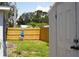 Backyard view of a wooden fence, shed, some greenery, and a partially visible chair at 204 36Th W St, Bradenton, FL 34205