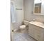 Functional bathroom with neutral tile floors, updated vanity, and a window for natural light at 204 36Th W St, Bradenton, FL 34205