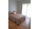 Bright bedroom features hardwood floors and a large window with sheer white curtains at 204 36Th W St, Bradenton, FL 34205