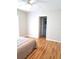 Cozy bedroom showcases hardwood floors and a doorway to the bathroom at 204 36Th W St, Bradenton, FL 34205