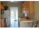 Functional kitchen with wooden cabinets and a view of the door leading to the backyard at 204 36Th W St, Bradenton, FL 34205