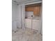 Bright laundry room with tile floors, a washer, a dryer, storage cabinets, and sheer curtain accents at 204 36Th W St, Bradenton, FL 34205
