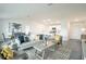 Open-concept living room and dining area with modern furnishings and an adjacent kitchen at 2081 Basin St, Port Charlotte, FL 33952