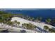 Aerial view of a beach with palm trees, a volleyball court, and clear blue water at 2105 19Th W St, Bradenton, FL 34205