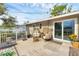 Inviting back deck with charming rattan chairs, table, and sliding glass door entrance into the home at 2105 19Th W St, Bradenton, FL 34205