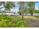 Expansive backyard with a well-manicured lawn, mature trees, and a deck, perfect for outdoor living and recreation at 2105 19Th W St, Bradenton, FL 34205