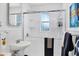Bright bathroom features a glass-enclosed shower, a pedestal sink, and wainscoting at 2105 19Th W St, Bradenton, FL 34205
