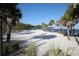 A serene beach with white sand, palm trees, and a volleyball net ready for some fun in the sun at 2105 19Th W St, Bradenton, FL 34205