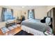 Well-lit bedroom features hardwood floors, two windows with curtains, and a TV at 2105 19Th W St, Bradenton, FL 34205