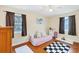 Cozy bedroom with hardwood floors, a daybed, and ample natural light from two windows at 2105 19Th W St, Bradenton, FL 34205