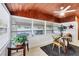 Bright dining room features many windows, wood paneled walls and a ceiling fan at 2105 19Th W St, Bradenton, FL 34205