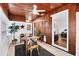 Dining room with a view into living room, wood paneling, white trim and ceiling fan at 2105 19Th W St, Bradenton, FL 34205