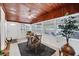 Cozy dining room featuring a glass door entry, wood walls and bright natural light at 2105 19Th W St, Bradenton, FL 34205