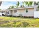 A beautifully landscaped yard surrounds this quaint single-story home at 2105 19Th W St, Bradenton, FL 34205