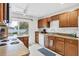 Kitchen with wooden cabinets, a white appliance package, and backyard views at 2105 19Th W St, Bradenton, FL 34205