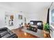 Spacious living room with hardwood floors, a leather sofa, and a view into the kitchen at 2105 19Th W St, Bradenton, FL 34205