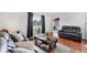 Cozy living room featuring hardwood floors, a comfortable sofa and bright natural lighting at 2105 19Th W St, Bradenton, FL 34205
