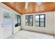 Bright sunroom with tile floors, wood-paneled ceiling, and windows overlooking the backyard at 2105 19Th W St, Bradenton, FL 34205